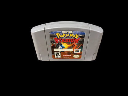 Pokémon Stadium game cartridge on a wooden surface